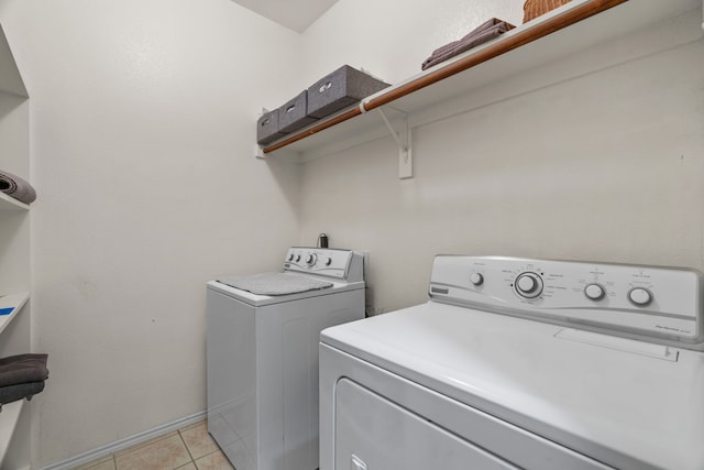 1092 Grand National Blvd, Fort Worth, TX 76179 - laundry room featuring light tile patterned floors, laundry area, and washer and clothes dryer