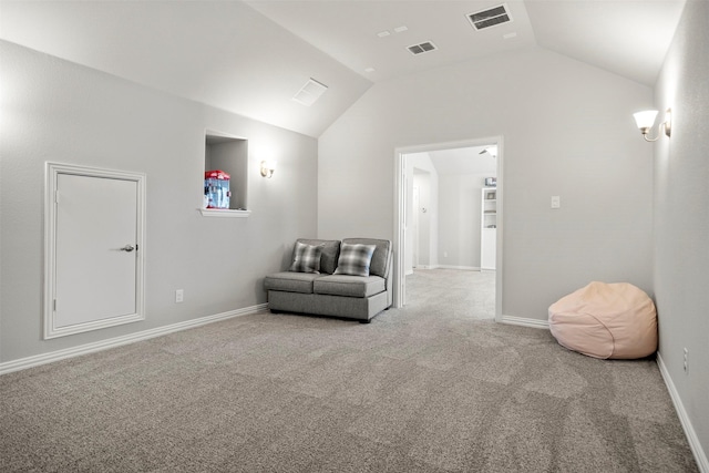 living area with visible vents, carpet floors, and vaulted ceiling
