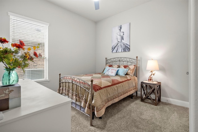 bedroom with light colored carpet, baseboards, ceiling fan, and multiple windows