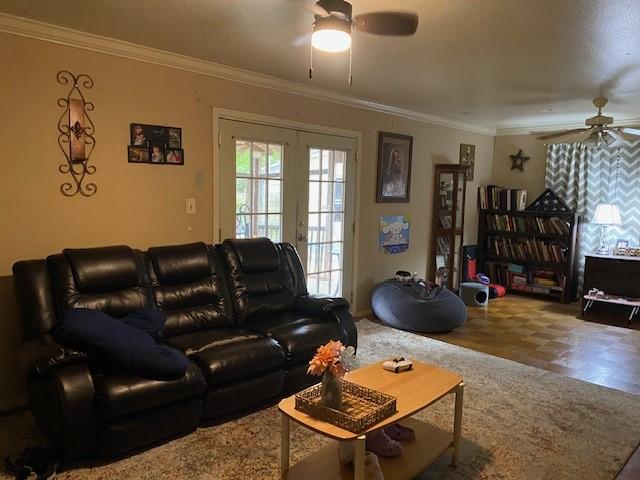 living room with crown molding, ceiling fan, and french doors