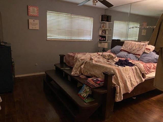 bedroom featuring baseboards, ceiling fan, and wood finished floors