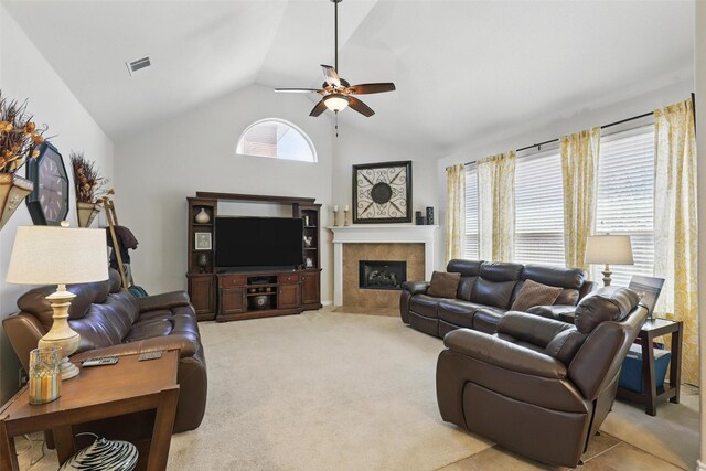 living room with light colored carpet, ceiling fan, visible vents, and a tiled fireplace