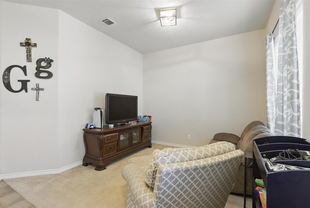 living room with baseboards, visible vents, and light carpet
