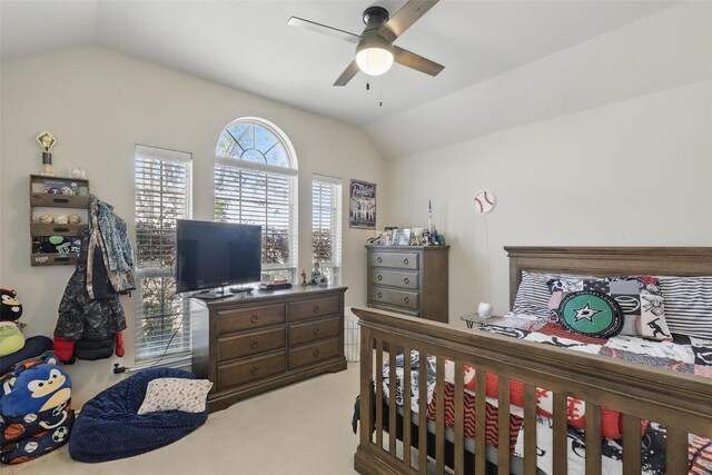 bedroom featuring a ceiling fan, light carpet, and lofted ceiling