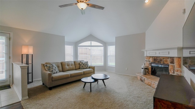 living room featuring ceiling fan, light colored carpet, a fireplace, baseboards, and lofted ceiling