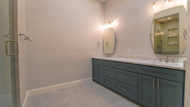 bathroom with double vanity, a sink, marble finish floor, and a shower stall