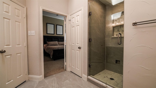 bathroom with baseboards, marble finish floor, and a stall shower