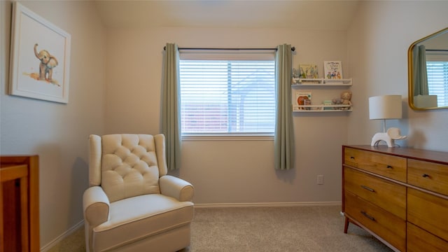 sitting room featuring carpet floors, baseboards, and a healthy amount of sunlight