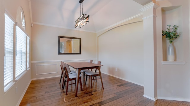 dining area with ornate columns, a healthy amount of sunlight, and wood finished floors