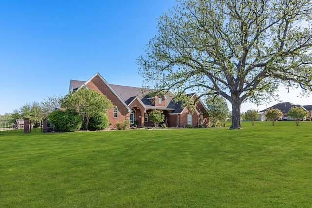 view of front of property featuring brick siding and a front yard