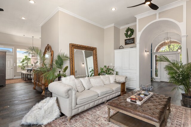 living area featuring recessed lighting, ornamental molding, wood finished floors, and ceiling fan with notable chandelier
