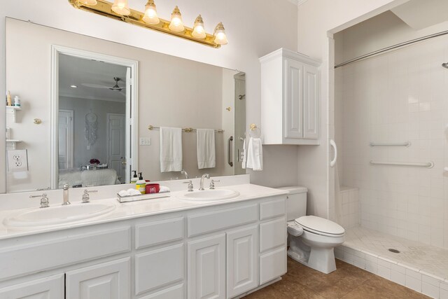ensuite bathroom featuring a sink, tile patterned floors, ensuite bathroom, and double vanity