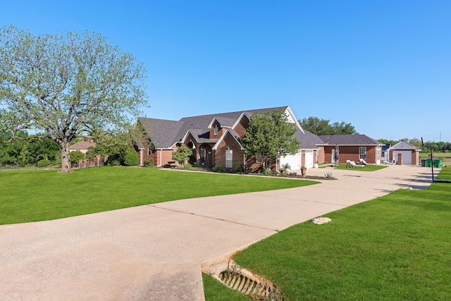 view of front of home with a garage, concrete driveway, and a front yard