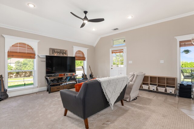 living area featuring crown molding, a healthy amount of sunlight, ceiling fan, and visible vents
