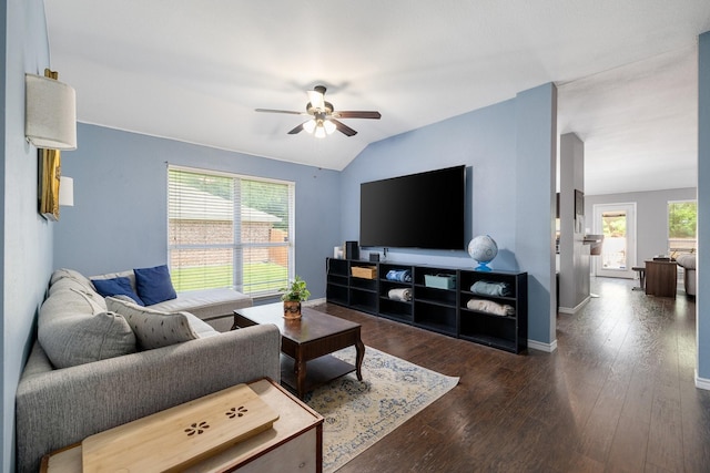 living area featuring vaulted ceiling, baseboards, a ceiling fan, and dark wood-type flooring
