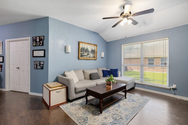 living area featuring dark wood-type flooring, a ceiling fan, baseboards, and vaulted ceiling