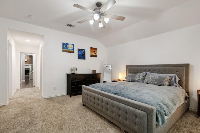 bedroom featuring carpet floors, baseboards, visible vents, and lofted ceiling