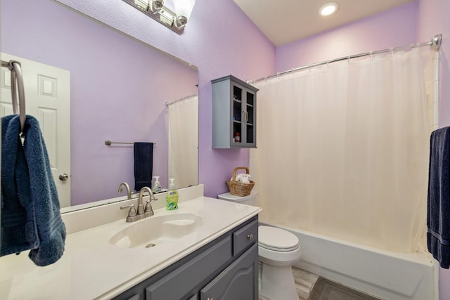 bathroom featuring recessed lighting, vanity, toilet, and shower / bath combination with curtain