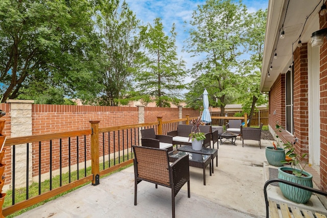 view of patio / terrace featuring a fenced backyard, outdoor dining space, and an outdoor living space