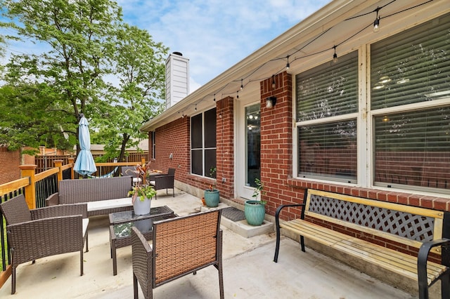 view of patio featuring fence and an outdoor hangout area