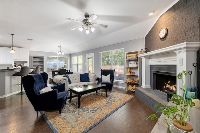 living room with visible vents, a ceiling fan, dark wood finished floors, and a brick fireplace