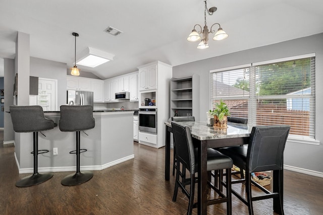 dining space with visible vents, baseboards, dark wood-type flooring, and vaulted ceiling