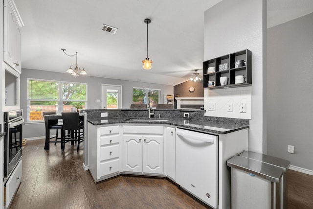 kitchen featuring oven, dishwasher, a chandelier, a peninsula, and visible vents