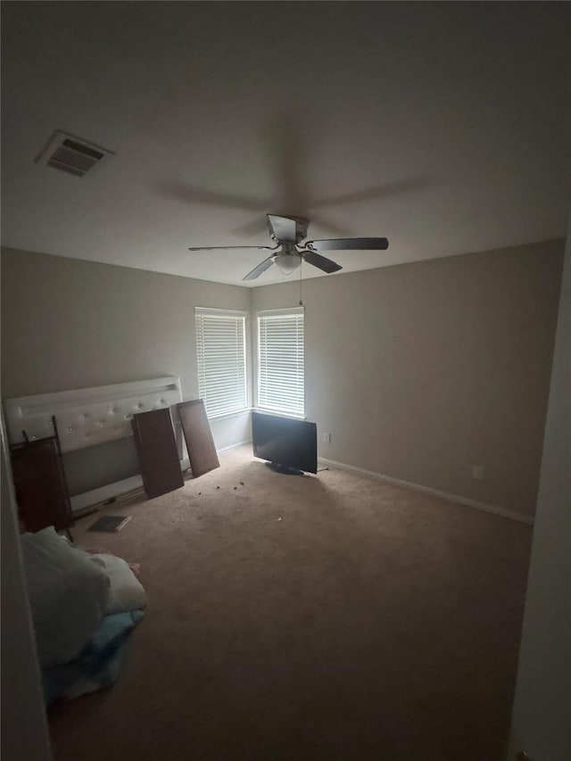 carpeted bedroom with ceiling fan, visible vents, and baseboards