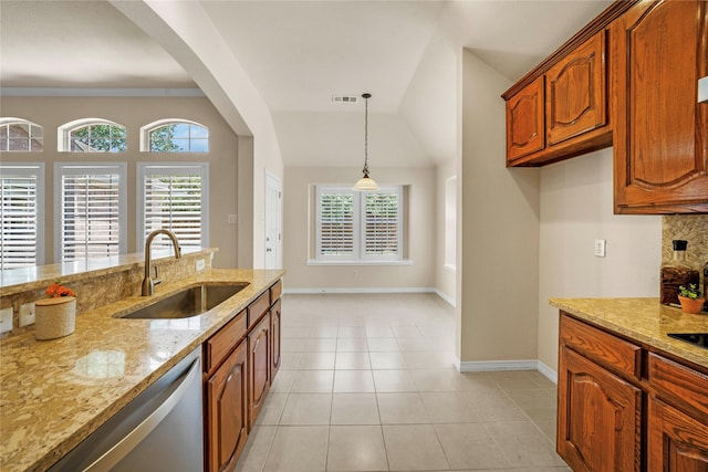 kitchen featuring brown cabinetry, visible vents, baseboards, a sink, and dishwasher