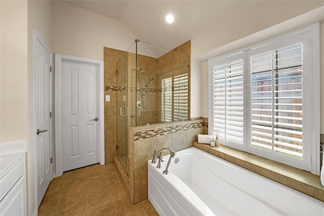full bathroom with a healthy amount of sunlight, vaulted ceiling, a stall shower, and a bath
