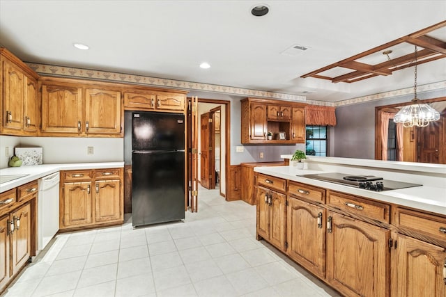 kitchen with appliances with stainless steel finishes, brown cabinets, a sink, a wainscoted wall, and wallpapered walls
