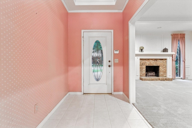 tiled entrance foyer with ornamental molding, a brick fireplace, and wallpapered walls