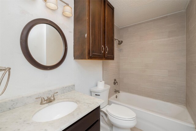 bathroom featuring vanity, washtub / shower combination, toilet, and a textured ceiling