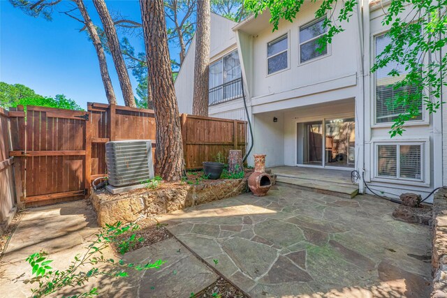view of patio with fence and central AC unit