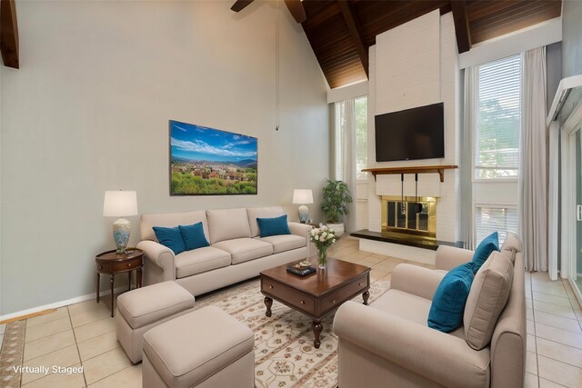 living room with beam ceiling, baseboards, high vaulted ceiling, wood ceiling, and light tile patterned floors