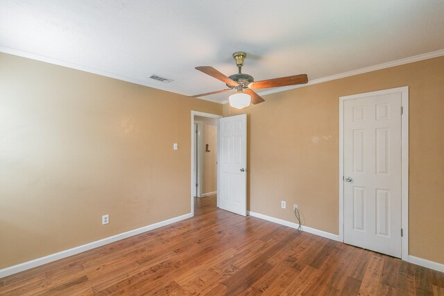 836 Springdale Rd, Bedford, TX 76021 - unfurnished bedroom featuring visible vents, ornamental molding, baseboards, and wood finished floors
