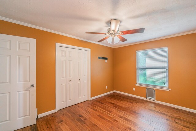 836 Springdale Rd, Bedford, TX 76021 - unfurnished bedroom featuring baseboards, crown molding, a closet, and hardwood / wood-style flooring