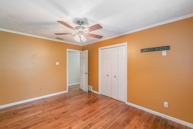 836 Springdale Rd, Bedford, TX 76021 - unfurnished bedroom featuring baseboards, a closet, wood finished floors, and visible vents