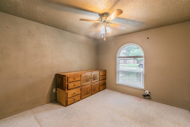 836 Springdale Rd, Bedford, TX 76021 - bedroom featuring a ceiling fan, a textured ceiling, and light carpet