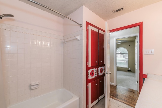 836 Springdale Rd, Bedford, TX 76021 - full bathroom featuring visible vents, tile patterned flooring, a textured ceiling, and shower / bathtub combination
