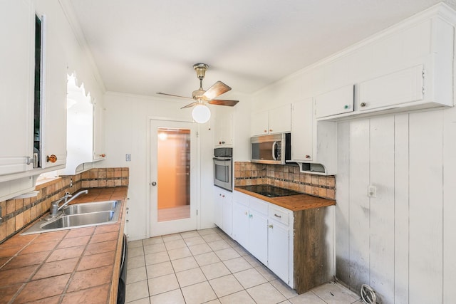 836 Springdale Rd, Bedford, TX 76021 - kitchen with tile countertops, tasteful backsplash, a sink, stainless steel appliances, and white cabinetry