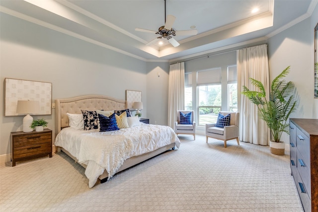 bedroom with a tray ceiling, light colored carpet, ornamental molding, and ceiling fan