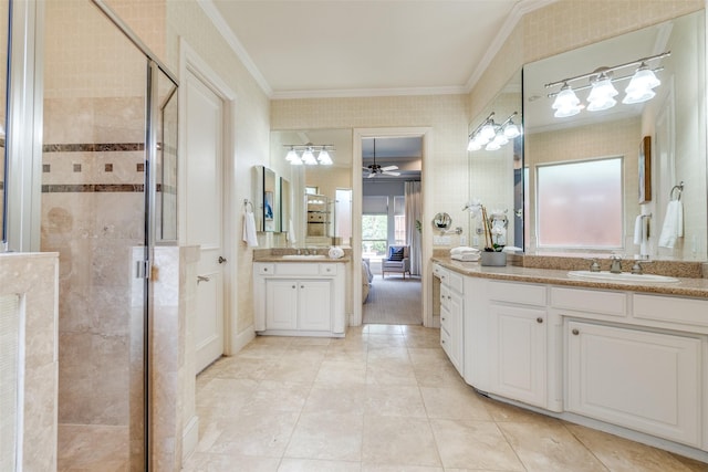 bathroom featuring crown molding, a ceiling fan, a sink, and a stall shower