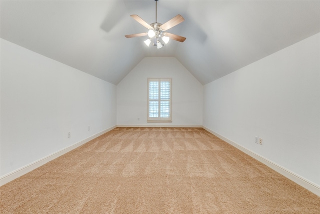 bonus room featuring baseboards, a ceiling fan, vaulted ceiling, and light carpet