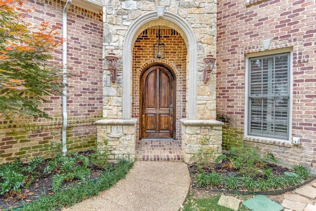 entrance to property with stone siding and brick siding