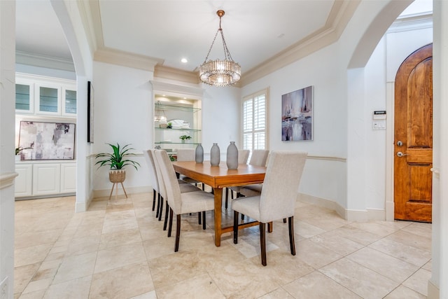 dining space featuring light tile patterned floors, ornamental molding, and a notable chandelier