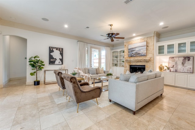 living room with crown molding, recessed lighting, ceiling fan, and a fireplace