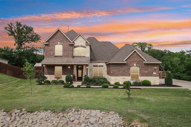 143 Dogwood Dr, Krugerville, TX 76227 - traditional-style house featuring fence, a shingled roof, stone siding, and a lawn