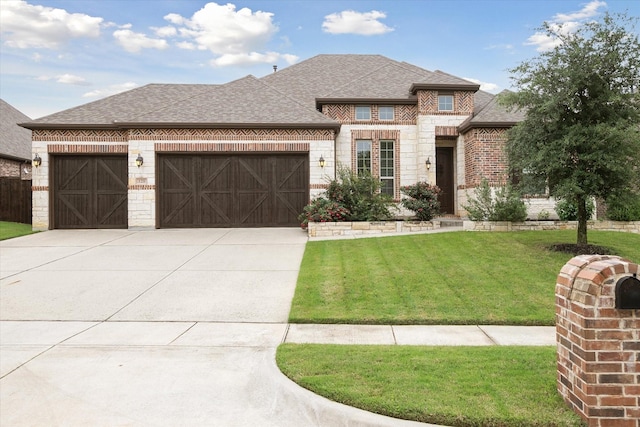 view of front of house featuring driveway, brick siding, a front lawn, an attached garage, and a shingled roof