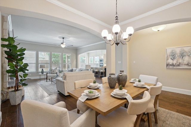 dining area featuring crown molding, arched walkways, baseboards, and dark wood-type flooring